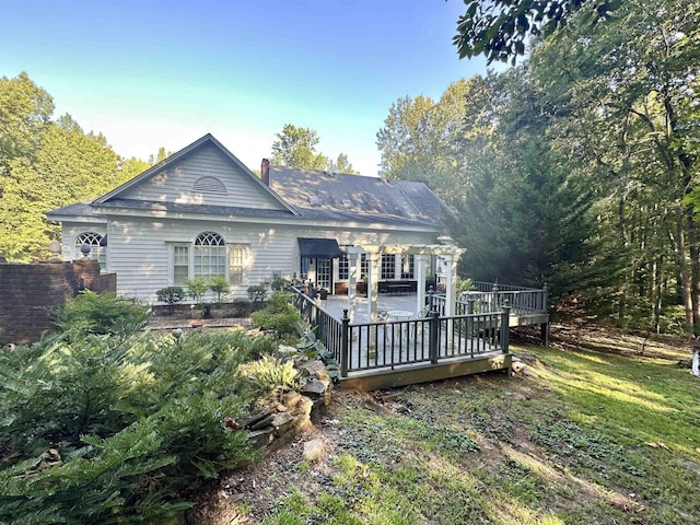 back of property featuring a wooden deck