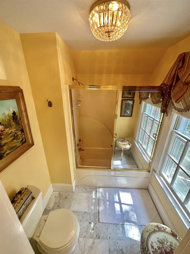 bathroom featuring toilet and enclosed tub / shower combo