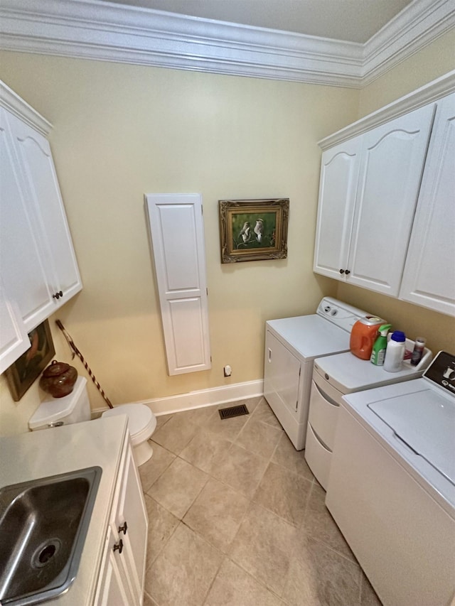 laundry room with separate washer and dryer, crown molding, sink, and light tile patterned flooring