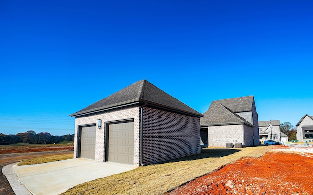 view of side of home featuring a garage