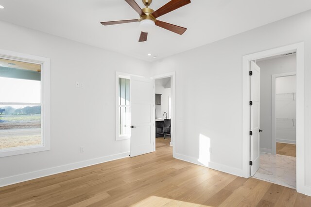 living room featuring wood-type flooring and ceiling fan with notable chandelier