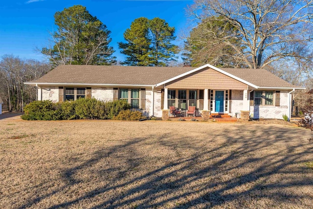 single story home with a porch and a front lawn