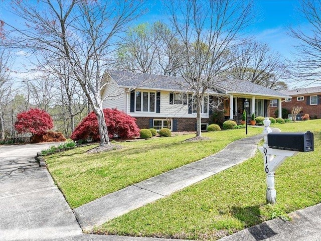 view of front of property with a front lawn and brick siding