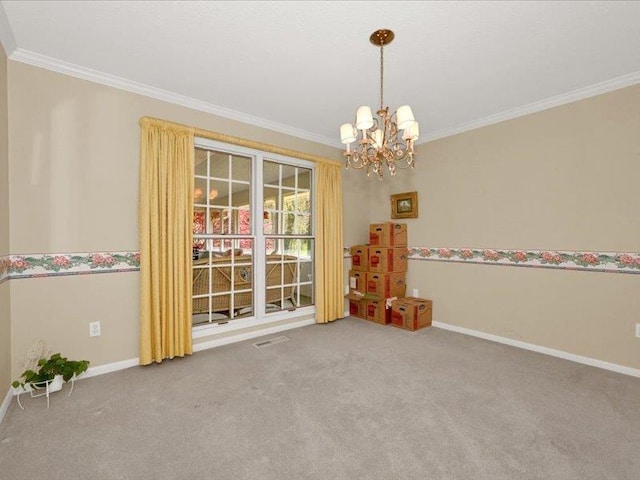 carpeted empty room with a notable chandelier, crown molding, and baseboards