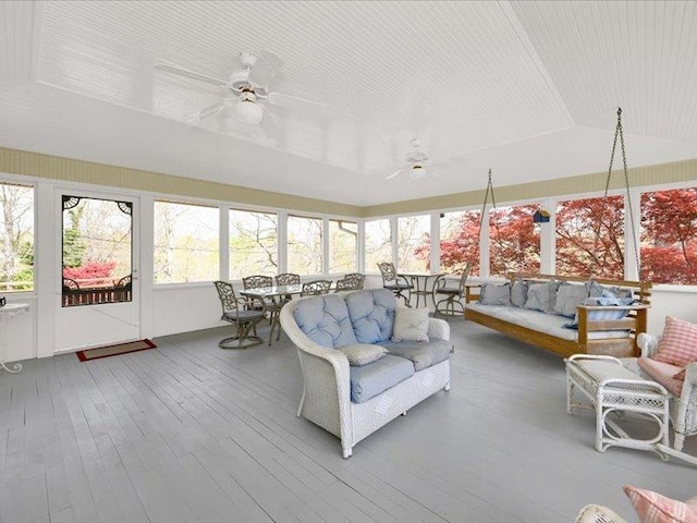 sunroom / solarium with an outdoor hangout area, outdoor dining area, vaulted ceiling, and a ceiling fan
