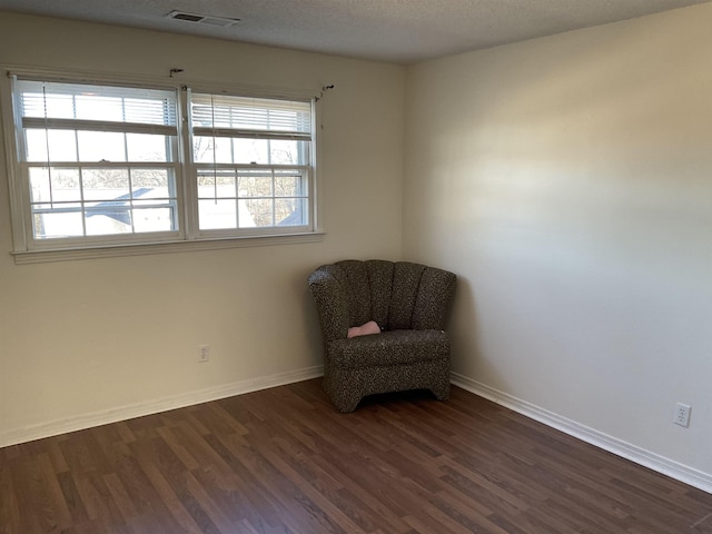 unfurnished room with dark hardwood / wood-style floors and a textured ceiling