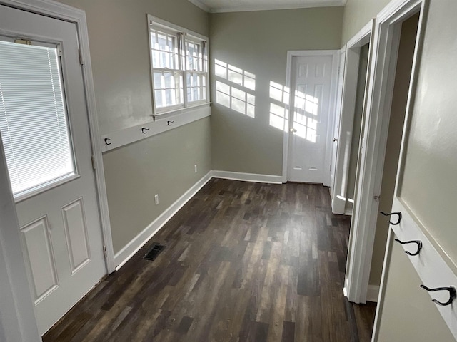 interior space featuring crown molding and dark wood-type flooring