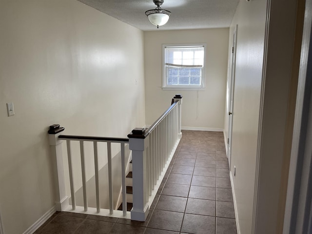 staircase featuring tile patterned floors and a textured ceiling