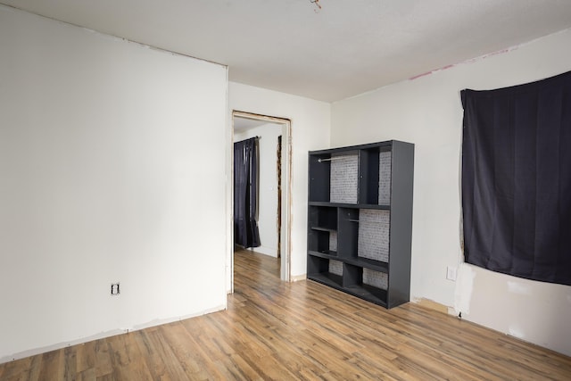 spare room with wood finished floors