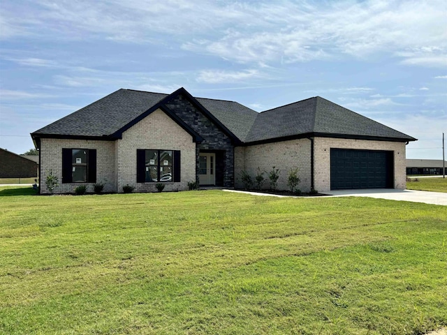 french provincial home featuring a garage and a front lawn