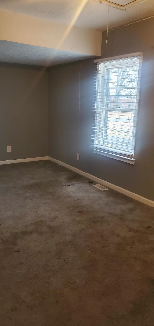 empty room with dark carpet