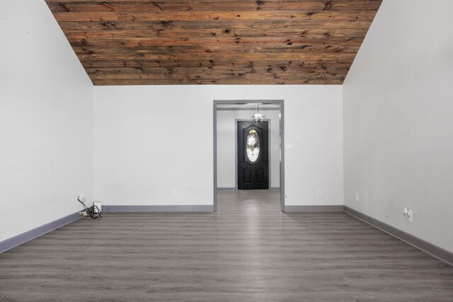 empty room with dark hardwood / wood-style floors, wooden ceiling, and vaulted ceiling