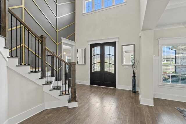  - entrance foyer featuring a healthy amount of sunlight, baseboards, french doors, and wood finished floors