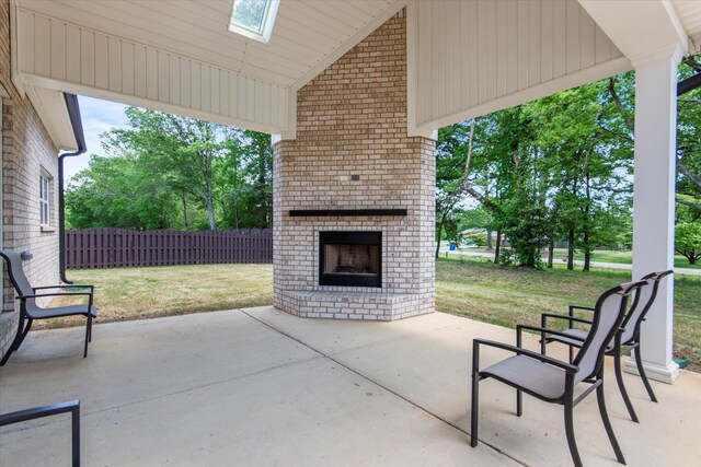  - view of patio with fence and an outdoor brick fireplace