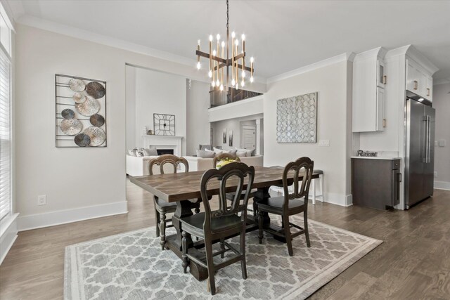  - dining area with baseboards, ornamental molding, dark wood-style flooring, and a fireplace