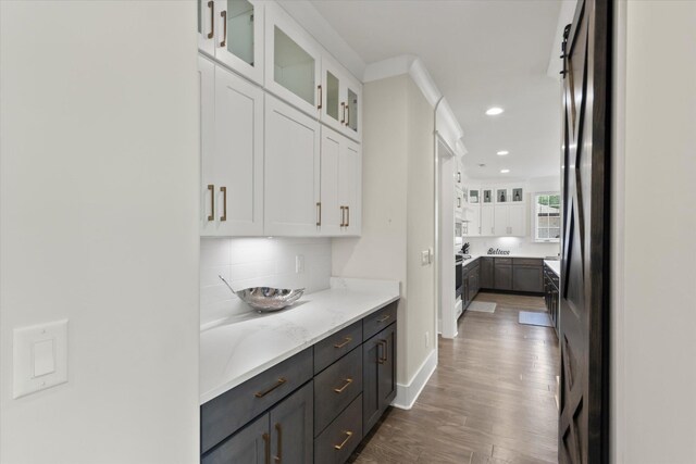  - bar featuring baseboards, backsplash, recessed lighting, and wood finished floors
