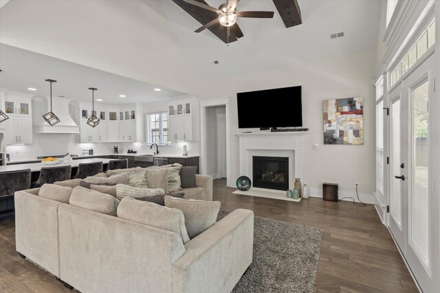  - living room featuring ceiling fan, visible vents, a fireplace with flush hearth, high vaulted ceiling, and dark wood-style floors