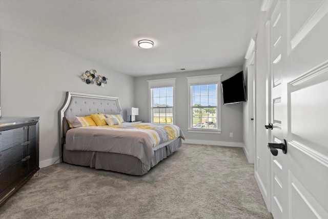  - bedroom with baseboards and light carpet