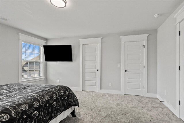  - bedroom with visible vents, carpet, and baseboards
