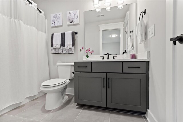  - bathroom with tile patterned flooring, vanity, toilet, baseboards, and visible vents