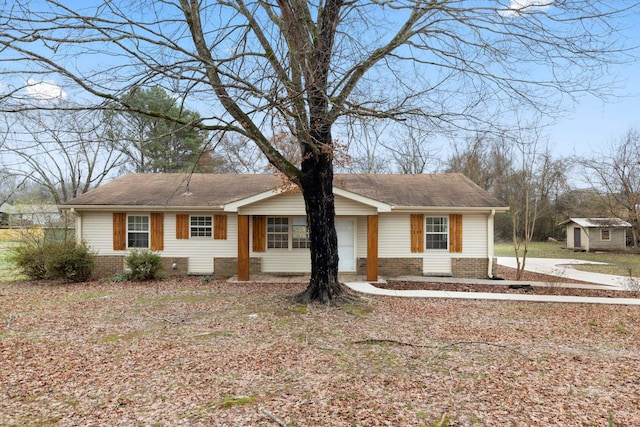 single story home with a storage shed