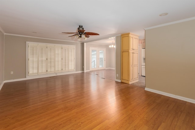 empty room with ceiling fan with notable chandelier, light hardwood / wood-style flooring, and ornamental molding