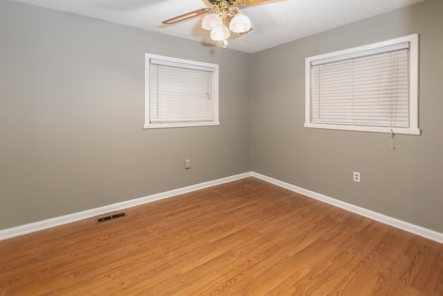 empty room with ceiling fan and light wood-type flooring