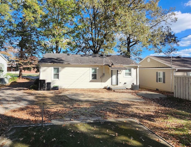 back of house with central AC unit