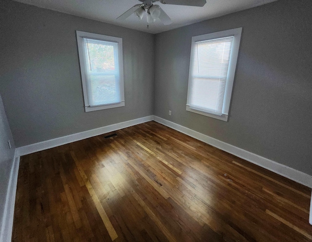 unfurnished room featuring dark hardwood / wood-style flooring and ceiling fan