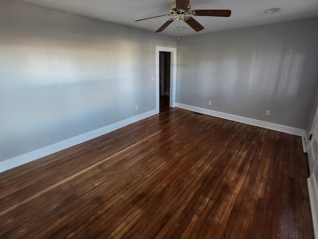 spare room with ceiling fan and dark hardwood / wood-style flooring