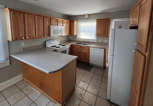 kitchen with sink, white appliances, kitchen peninsula, and light tile patterned floors