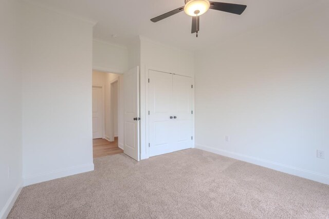 unfurnished bedroom with ceiling fan and light carpet