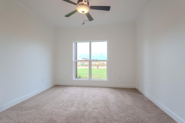 empty room featuring carpet flooring and ceiling fan