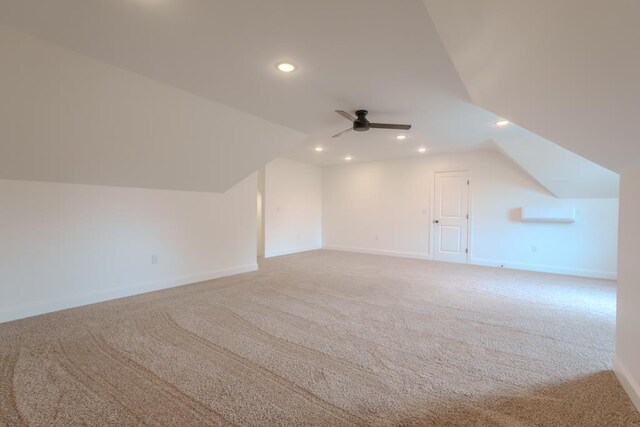 bonus room with carpet, ceiling fan, a wall unit AC, and vaulted ceiling