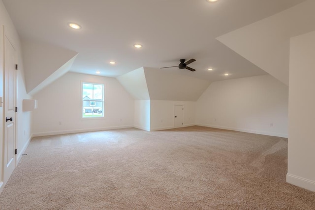 bonus room featuring ceiling fan, light colored carpet, and vaulted ceiling