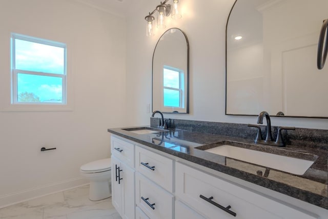 bathroom featuring vanity, toilet, a healthy amount of sunlight, and crown molding