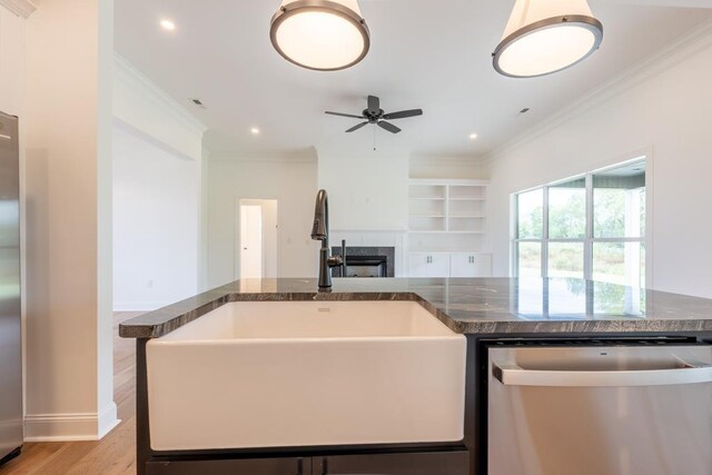 kitchen with ceiling fan, sink, light hardwood / wood-style flooring, stainless steel dishwasher, and crown molding