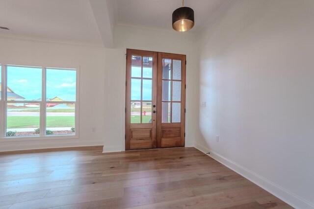 doorway featuring french doors, light hardwood / wood-style floors, and crown molding