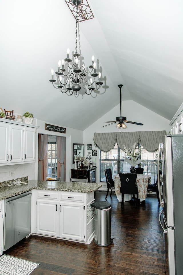  - kitchen featuring stainless steel appliances, a chandelier, vaulted ceiling, a peninsula, and white cabinetry