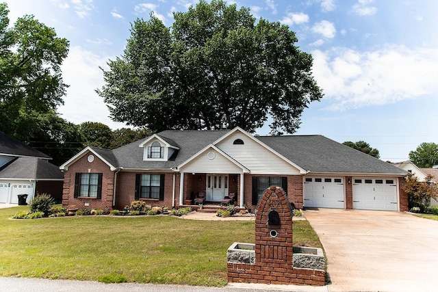  - traditional-style house with a garage, brick siding, concrete driveway, a front yard, and a porch