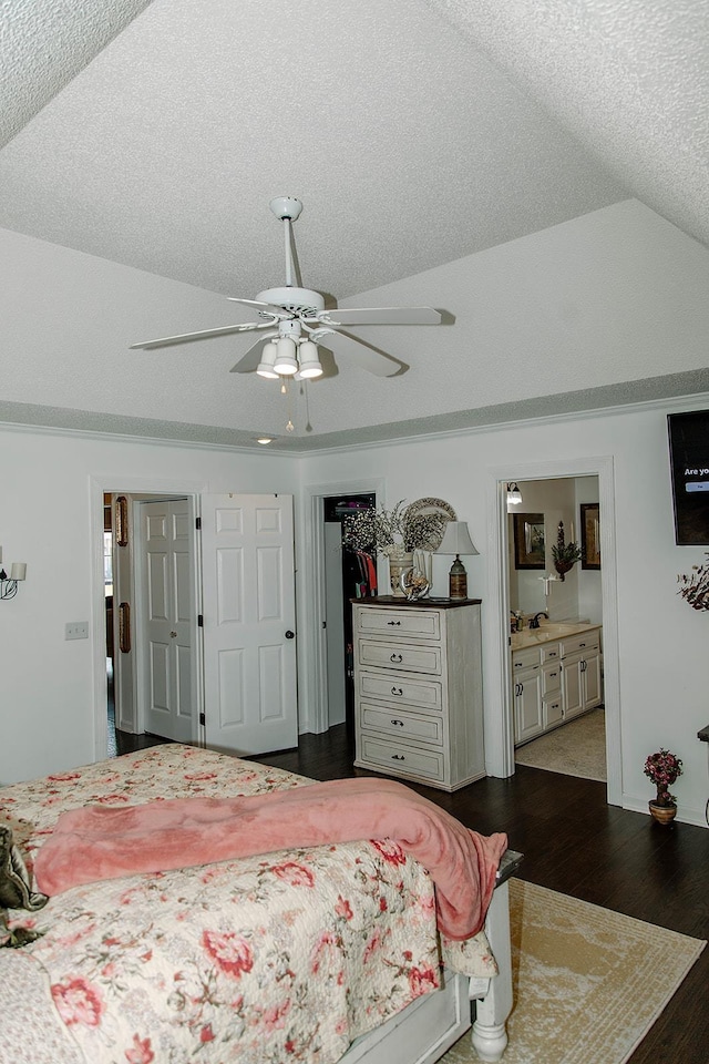  - bedroom featuring dark wood-style flooring, a textured ceiling, ensuite bathroom, a ceiling fan, and a closet