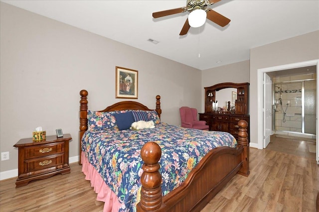  - bedroom with ensuite bathroom, light wood-type flooring, and ceiling fan