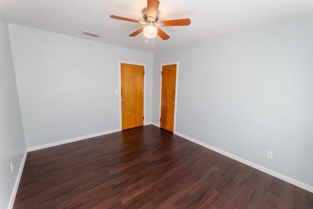 empty room featuring dark hardwood / wood-style floors and ceiling fan