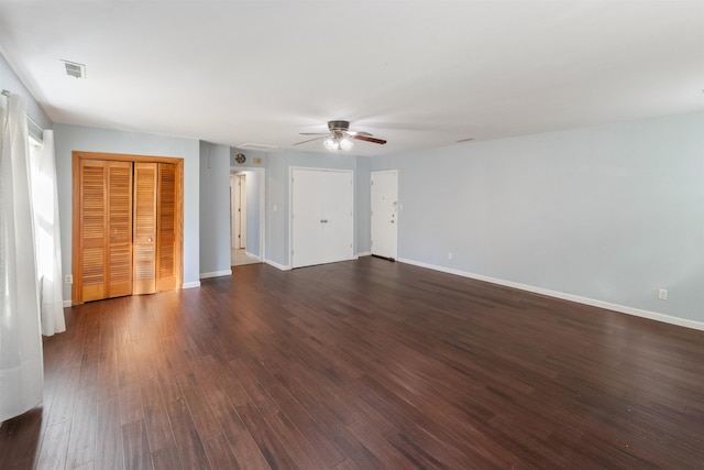 empty room with ceiling fan and dark hardwood / wood-style flooring