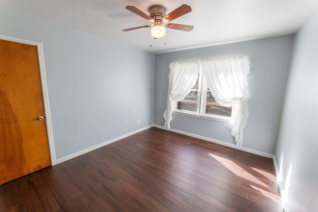 unfurnished room with ceiling fan and dark hardwood / wood-style flooring