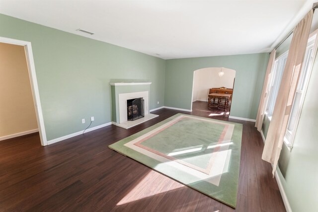 unfurnished living room with dark hardwood / wood-style floors