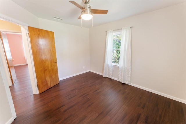 spare room featuring ceiling fan and dark hardwood / wood-style flooring