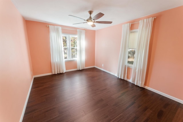 spare room featuring dark hardwood / wood-style flooring and ceiling fan