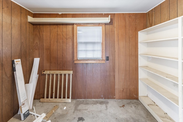 spare room featuring wood walls