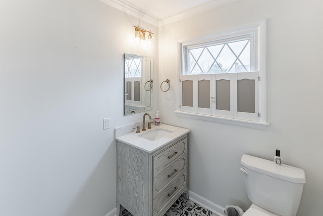 half bathroom with ornamental molding, vanity, toilet, and baseboards